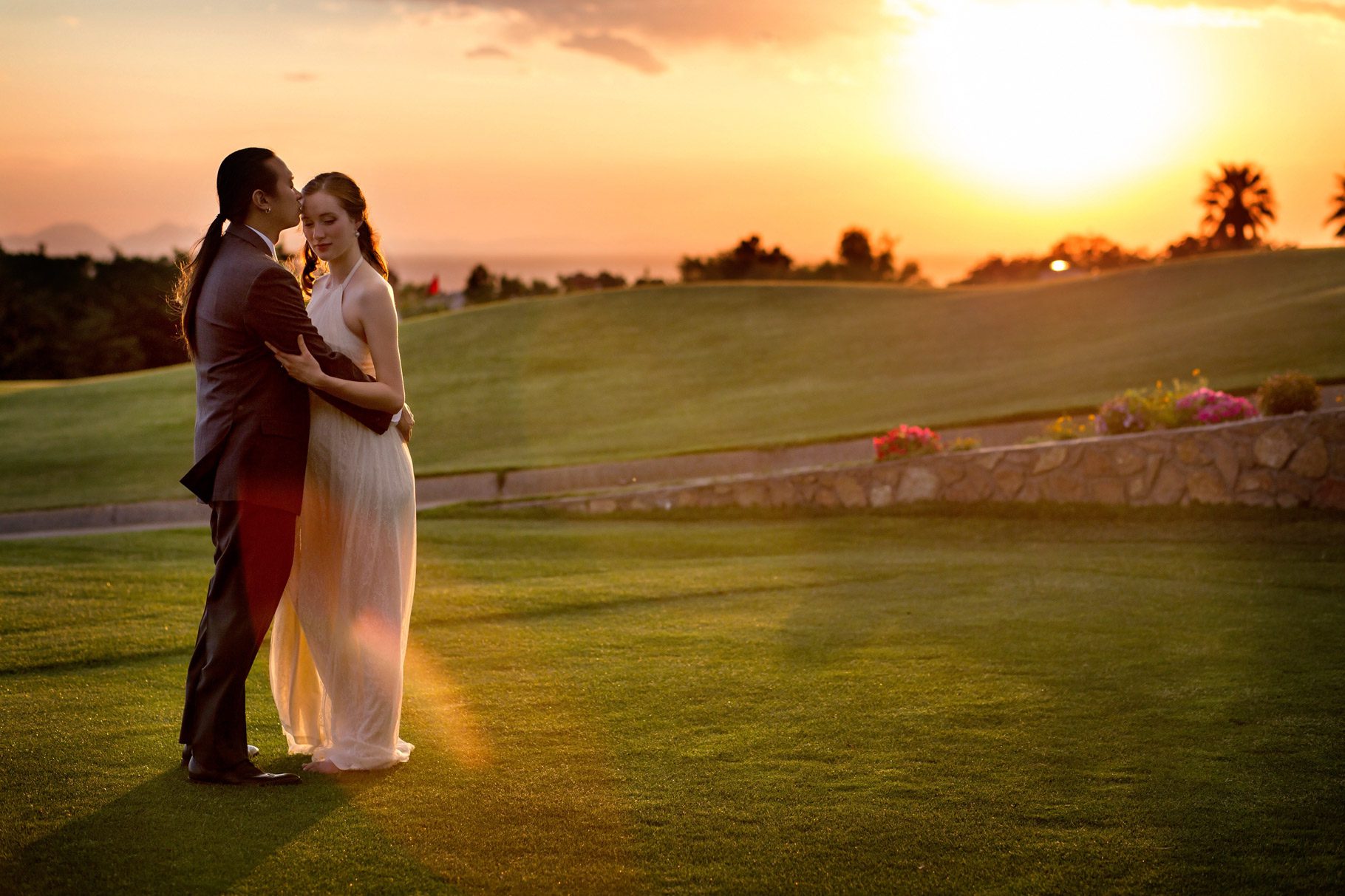 bride and groom embrace at sunset on the el paso country club golf course